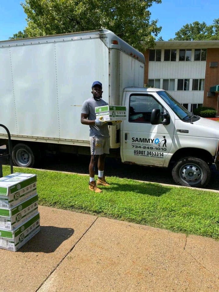 Sammy unloading boxes beside the SammyO's Moving Company truck